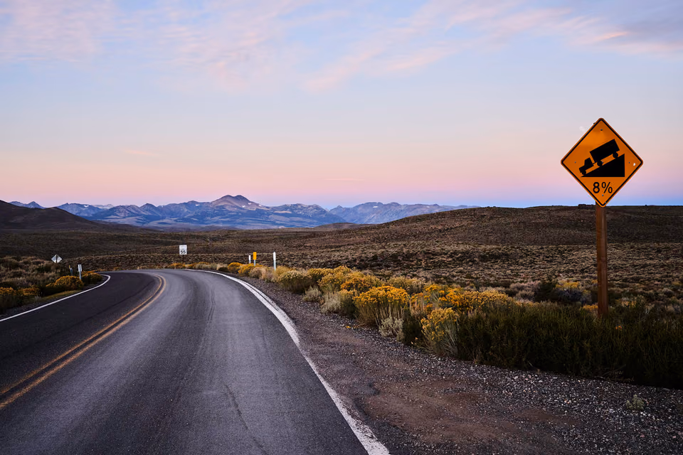 a road with a sign on it that says "road closed"
