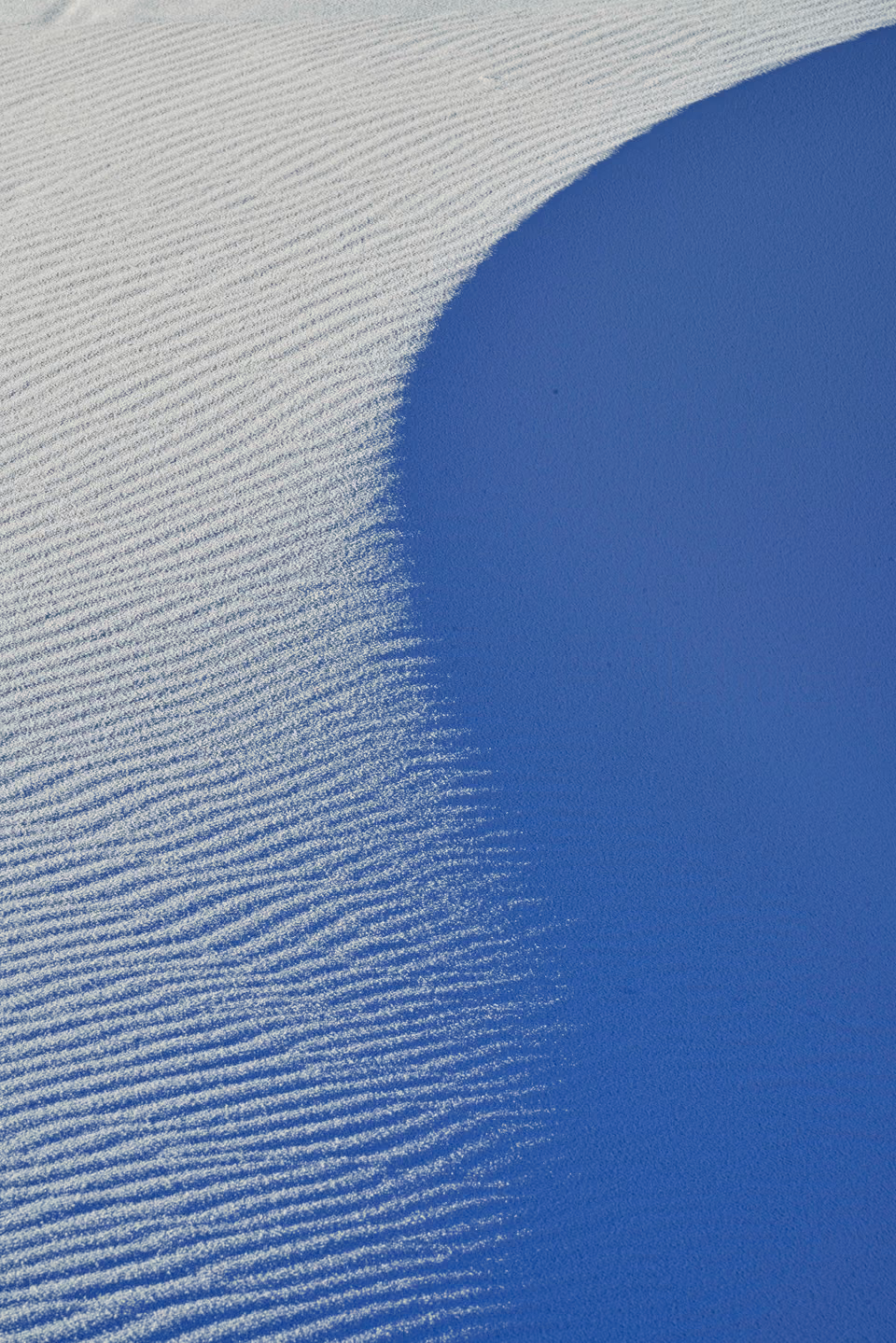 a person riding a snowboard down a hill
