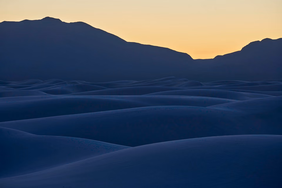 a desert landscape with mountains in the background
