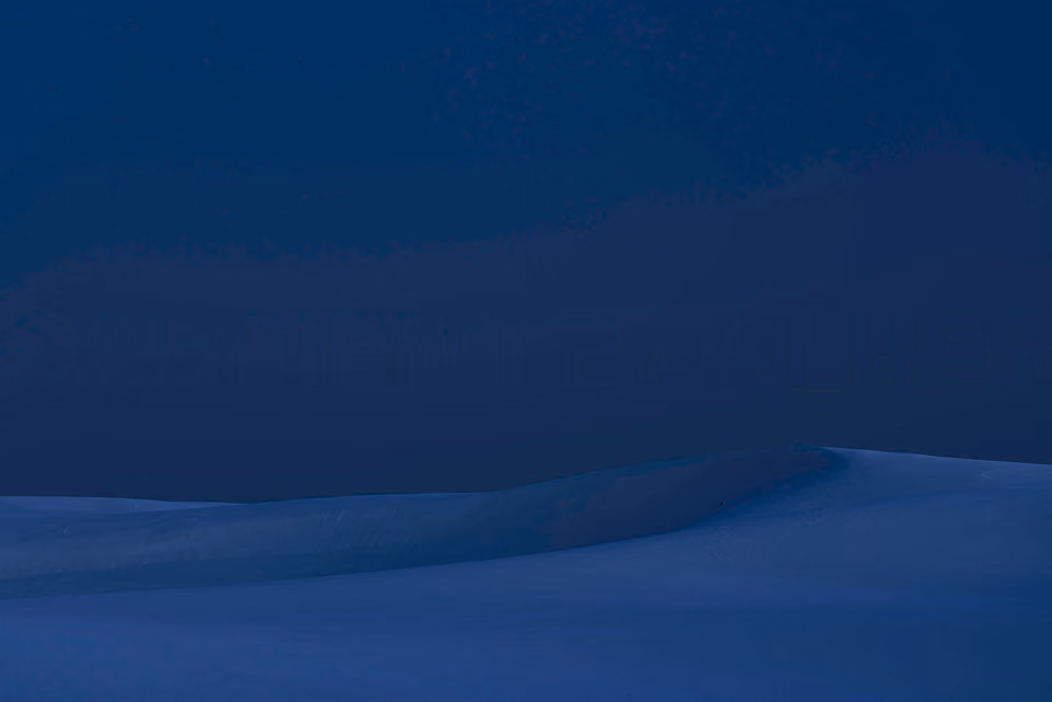 a person standing on top of a hill in the dark
