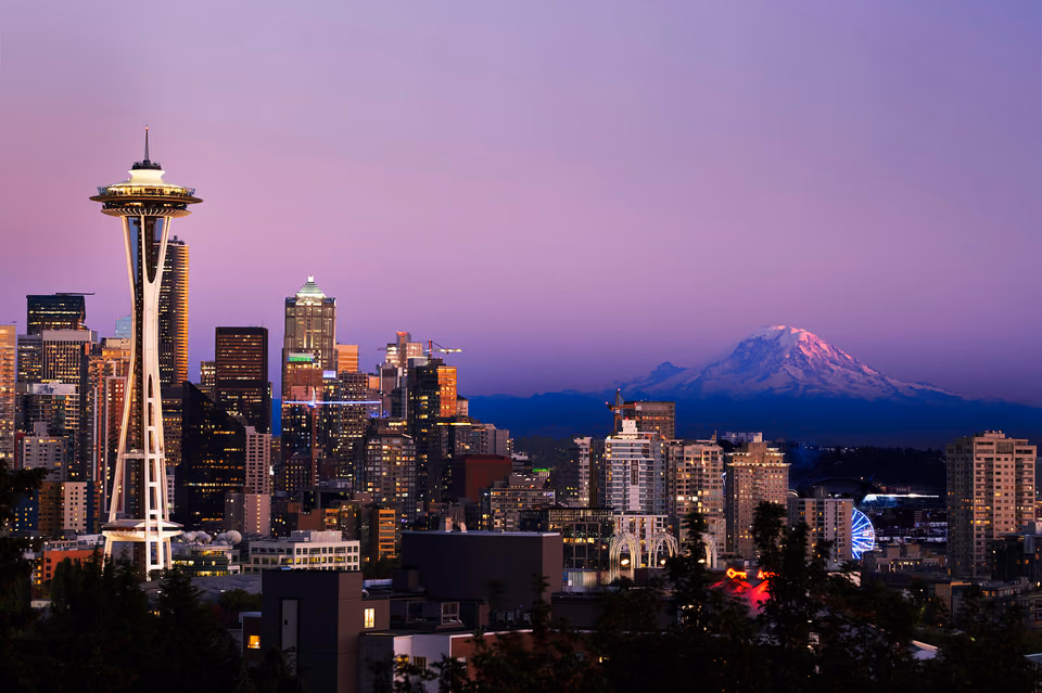 a city skyline with a mountain in the background
