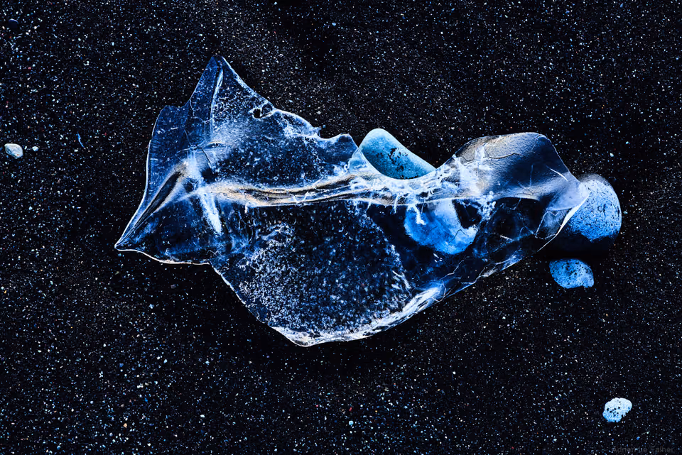 a broken piece of ice on a black background

