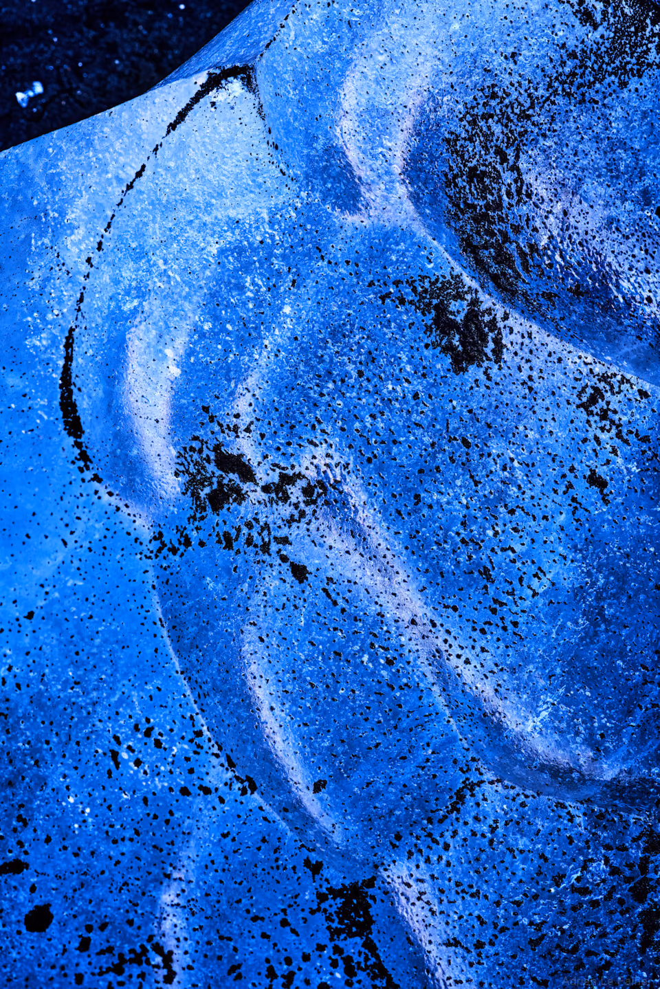 a close up of a blue surfboard with a hole in it
