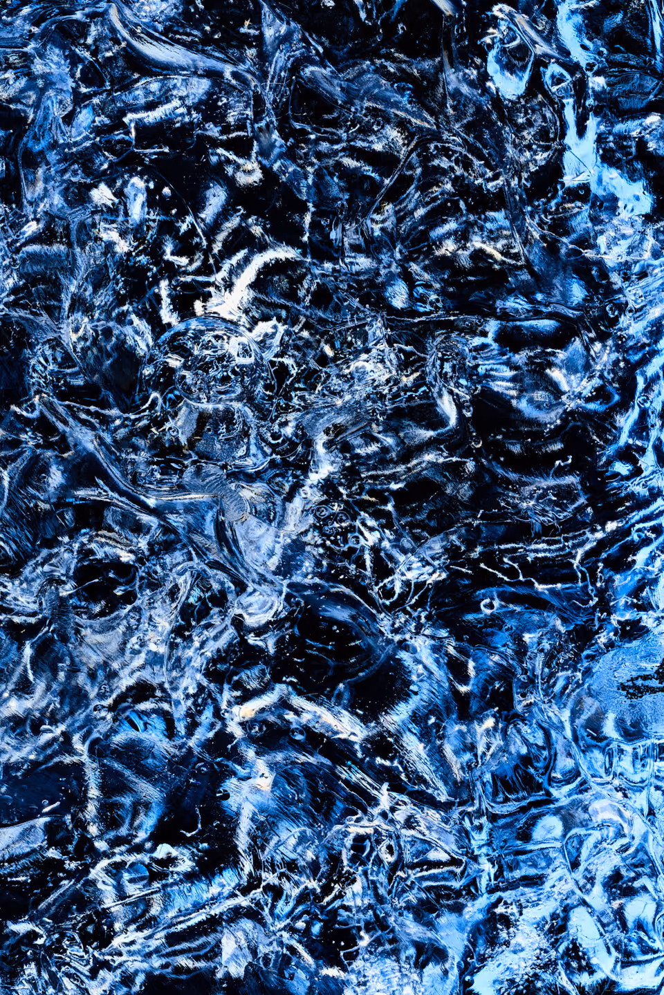 blue water with white and black swirls
