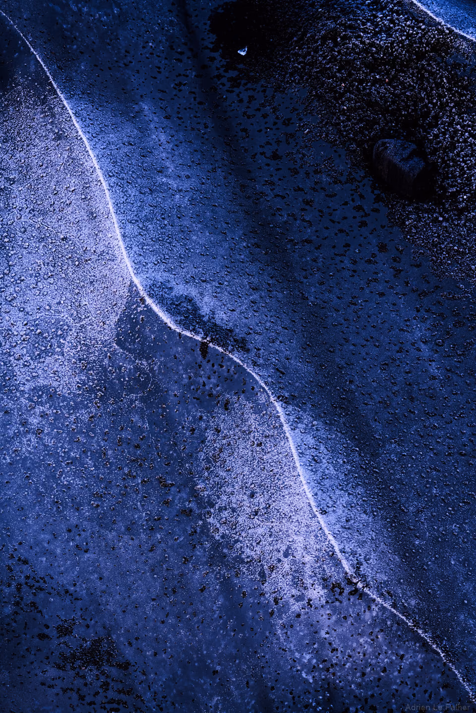 a person riding a skateboard on a wet road
