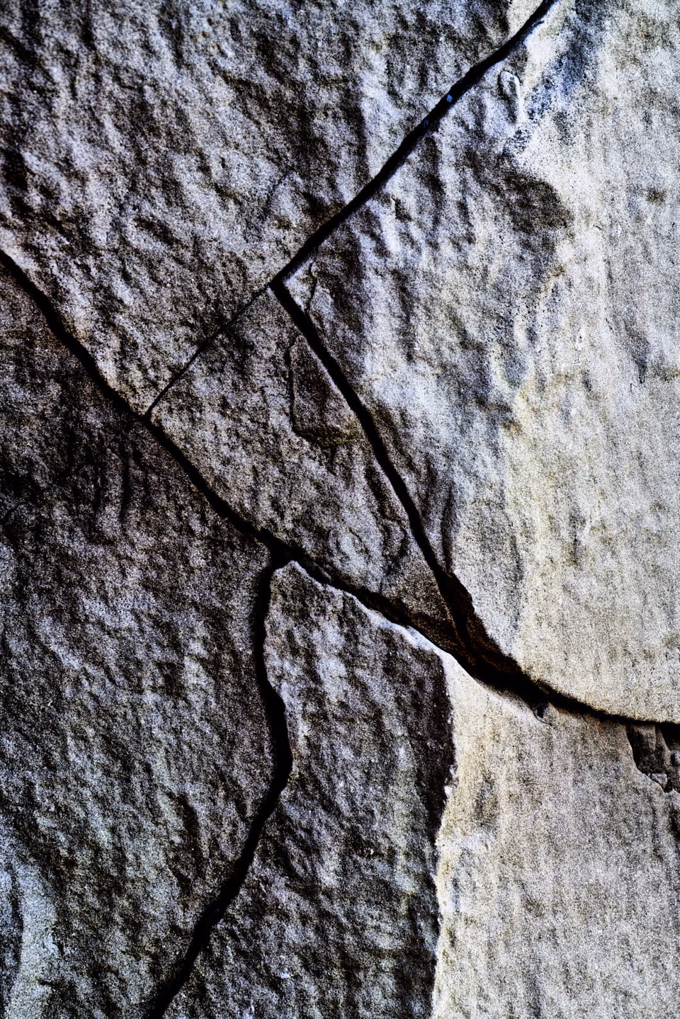 a close up of a rock with cracks
