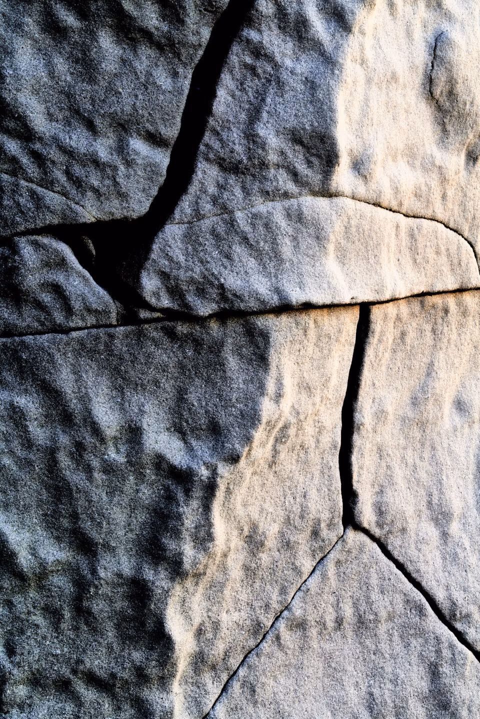 a close up of a rock with cracks
