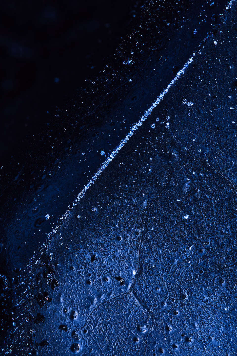 a close up of a blue surface with water droplets
