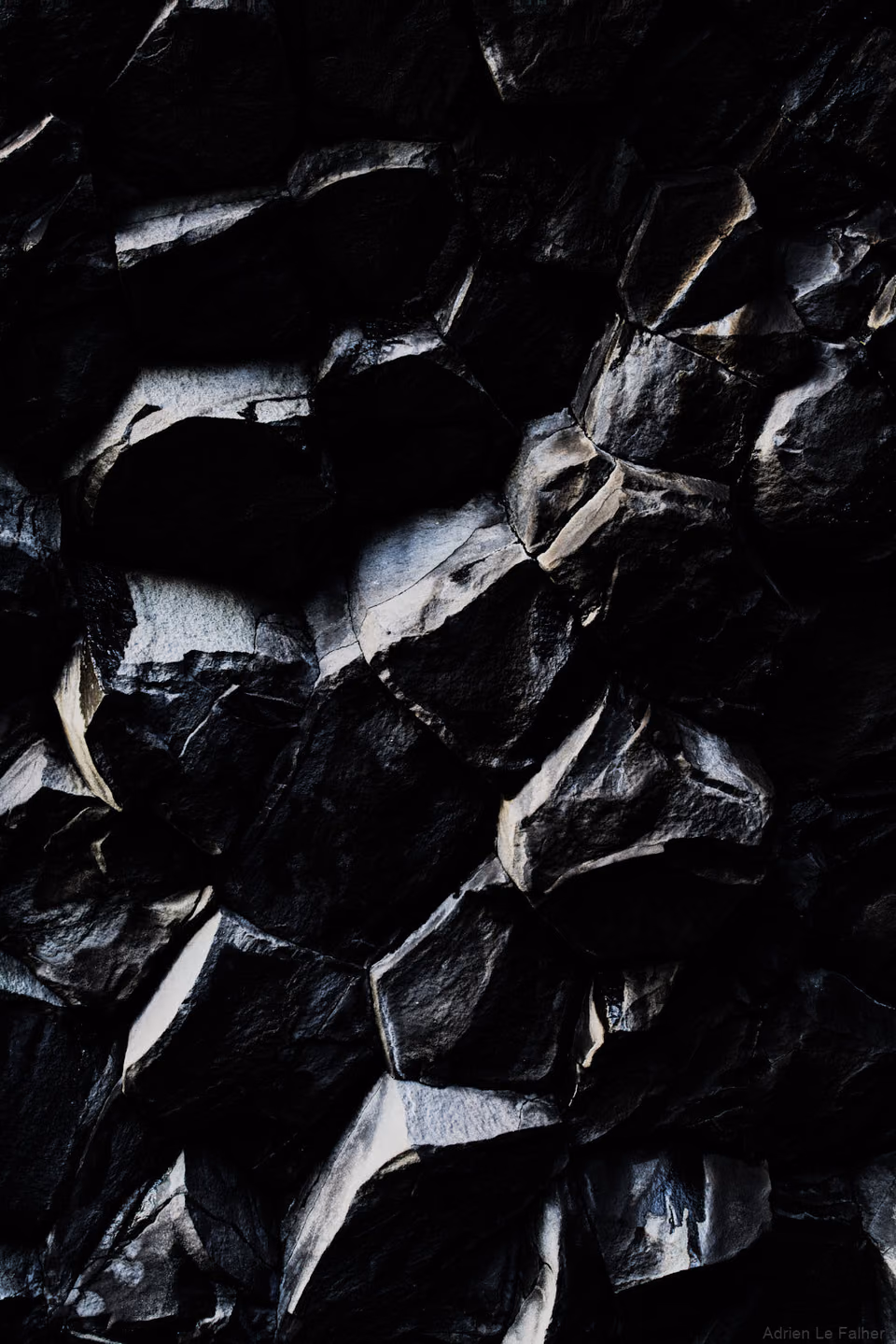 a black and white photo of a rock wall
