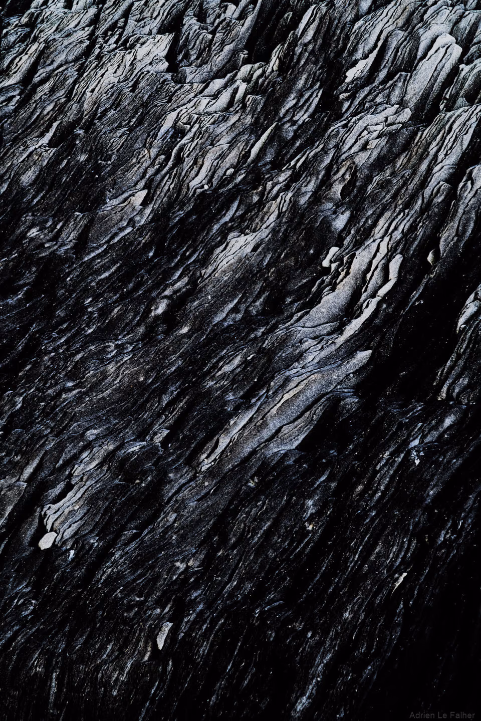 a black and white photo of a rock formation
