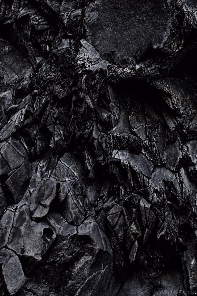 a black and white photo of a pile of coal
