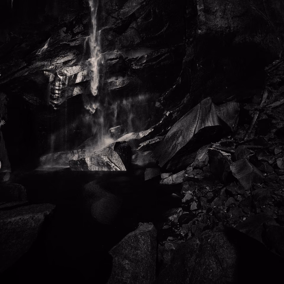 a black and white photo of a waterfall
