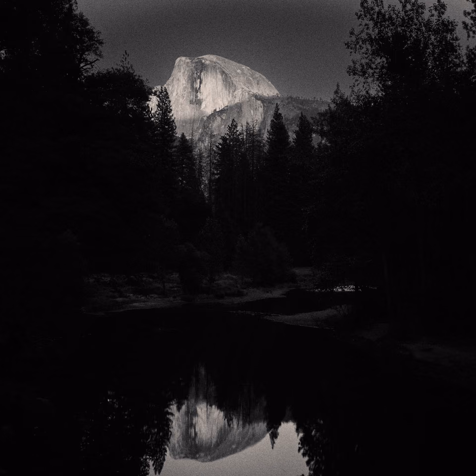 half dome reflected in the water
