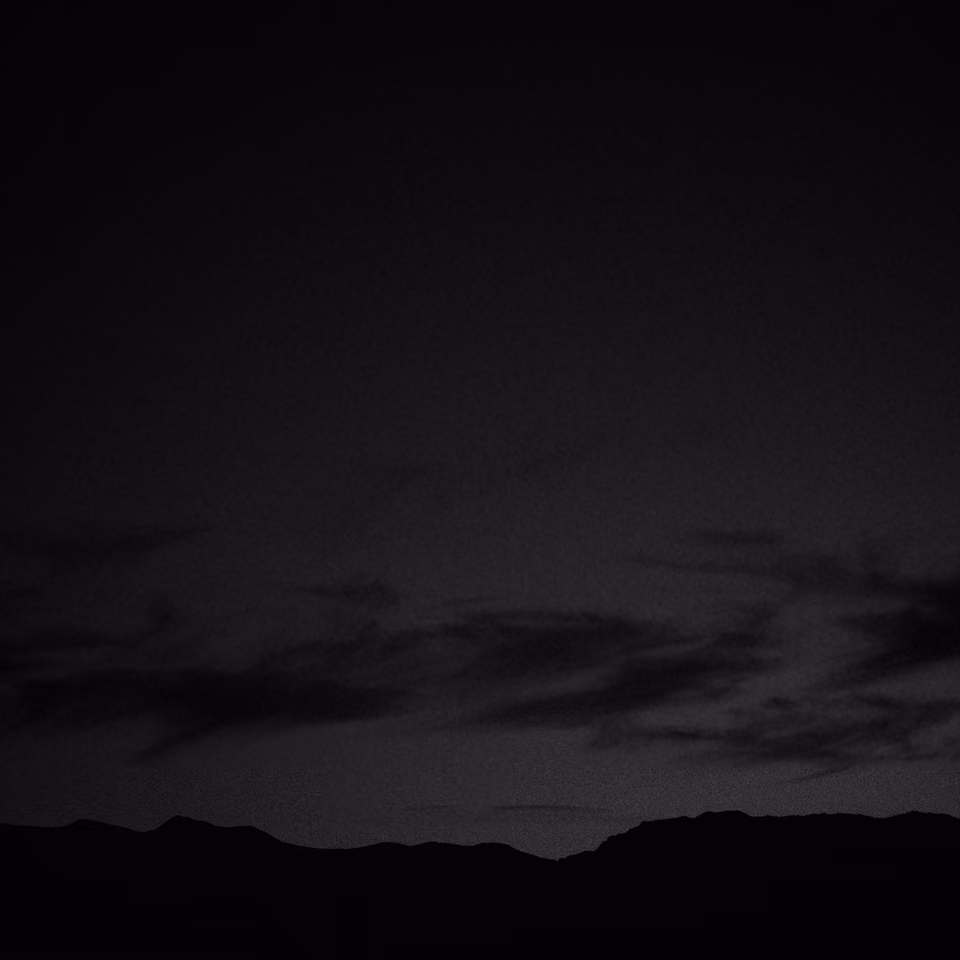 a black and white photo of a plane flying in the sky
