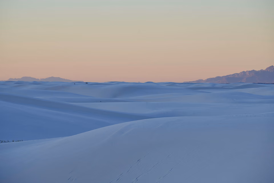 a person is walking on a snowy hill
