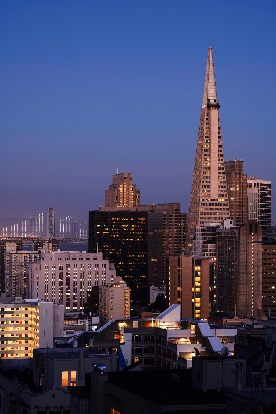 a city skyline with a tall building in the background
