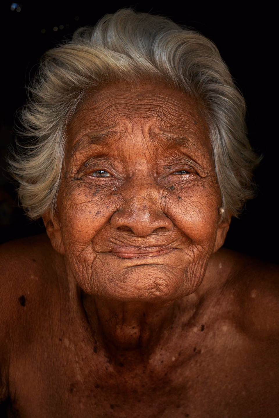 an old woman with wrinkles on her face
