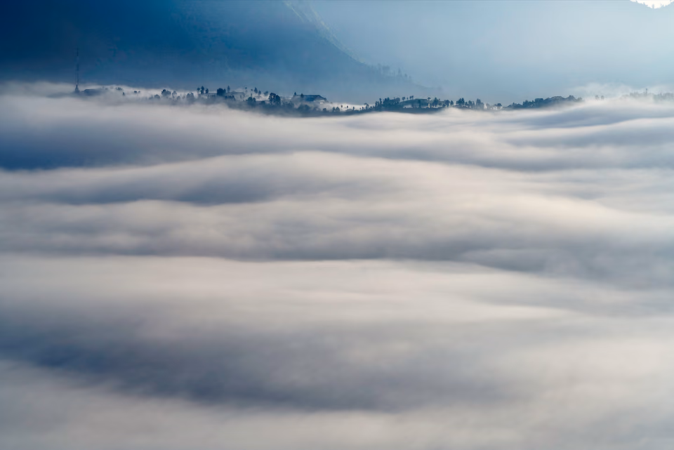 a view of the clouds above a mountain range
