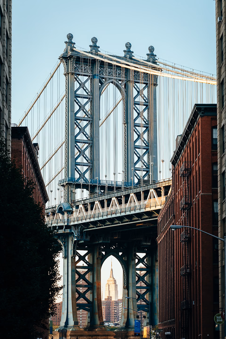 a bridge over a city street with cars driving under it
