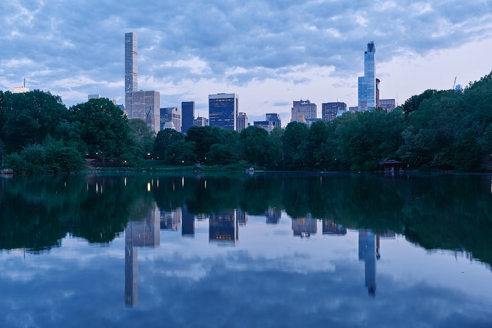 a city skyline reflected in a lake
