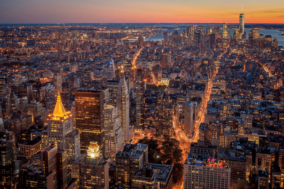new york city at night with skyscrapers and lights
