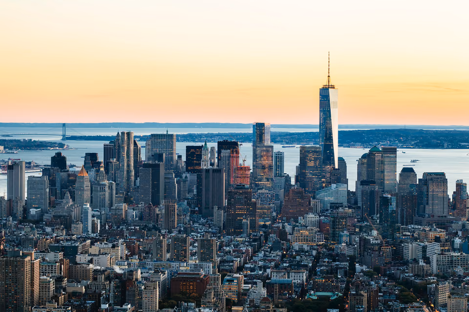 a city skyline with a large building in the middle
