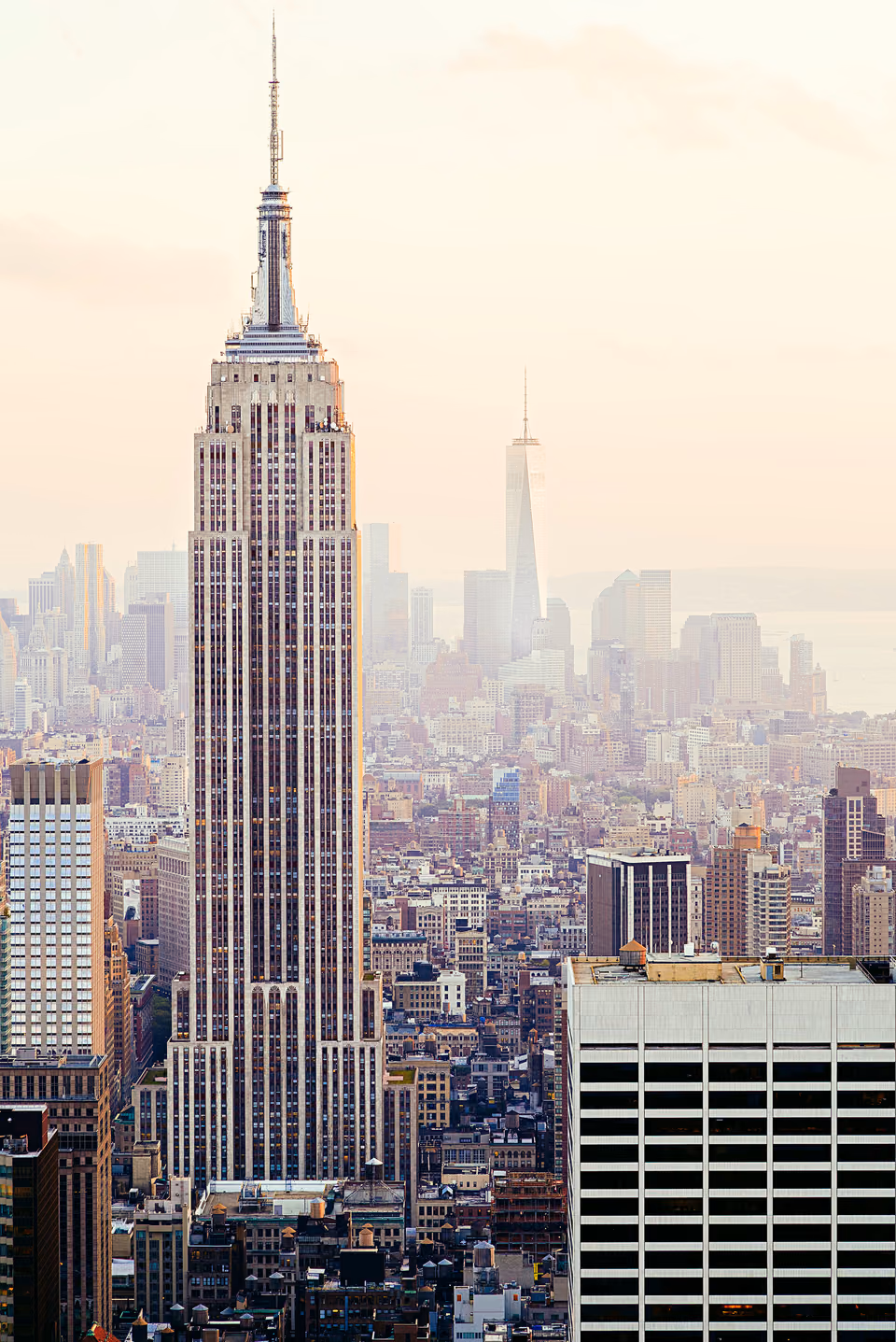 a city skyline with a large building in the middle
