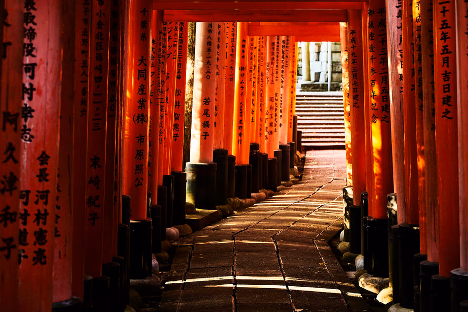 a pathway with many pillars and writing on it
