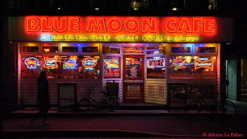 a neon blue moon cafe sign

