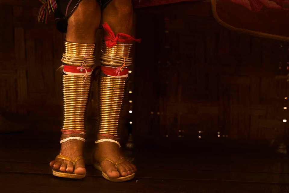 a person wearing gold and silver shoes and legs
