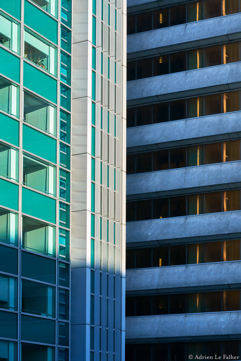 a tall building with a green window and a red light
