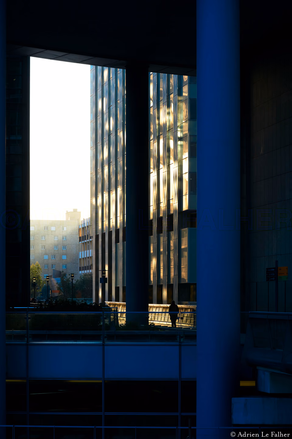 a person walking down a sidewalk next to a building
