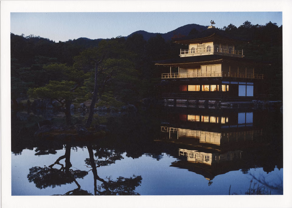 a reflection of a building in a lake
