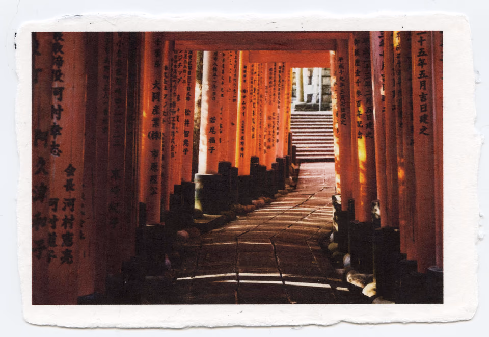 a photo of a red tori gate with a path leading to it
