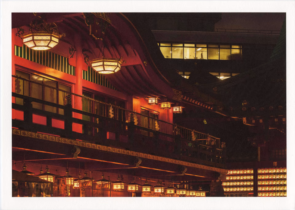a building with a red roof and lights
