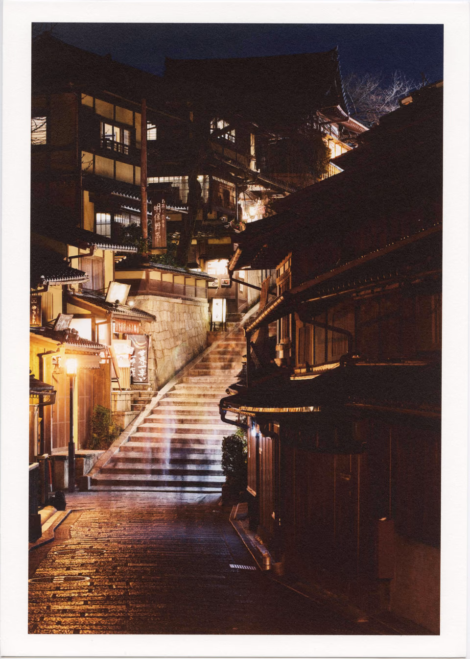 a stairway leading up to a building at night

