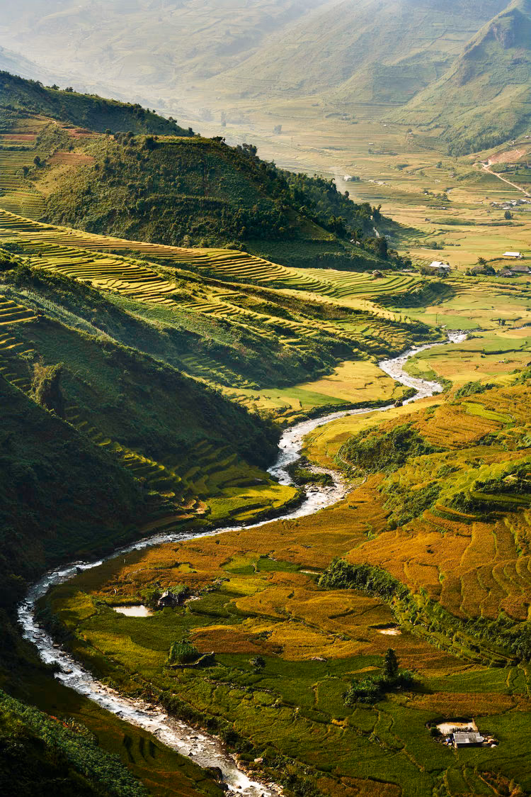 a valley with a river running through it
