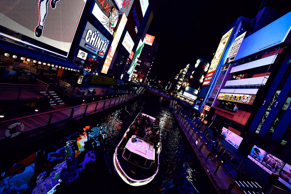 a boat is traveling down a canal in a city
