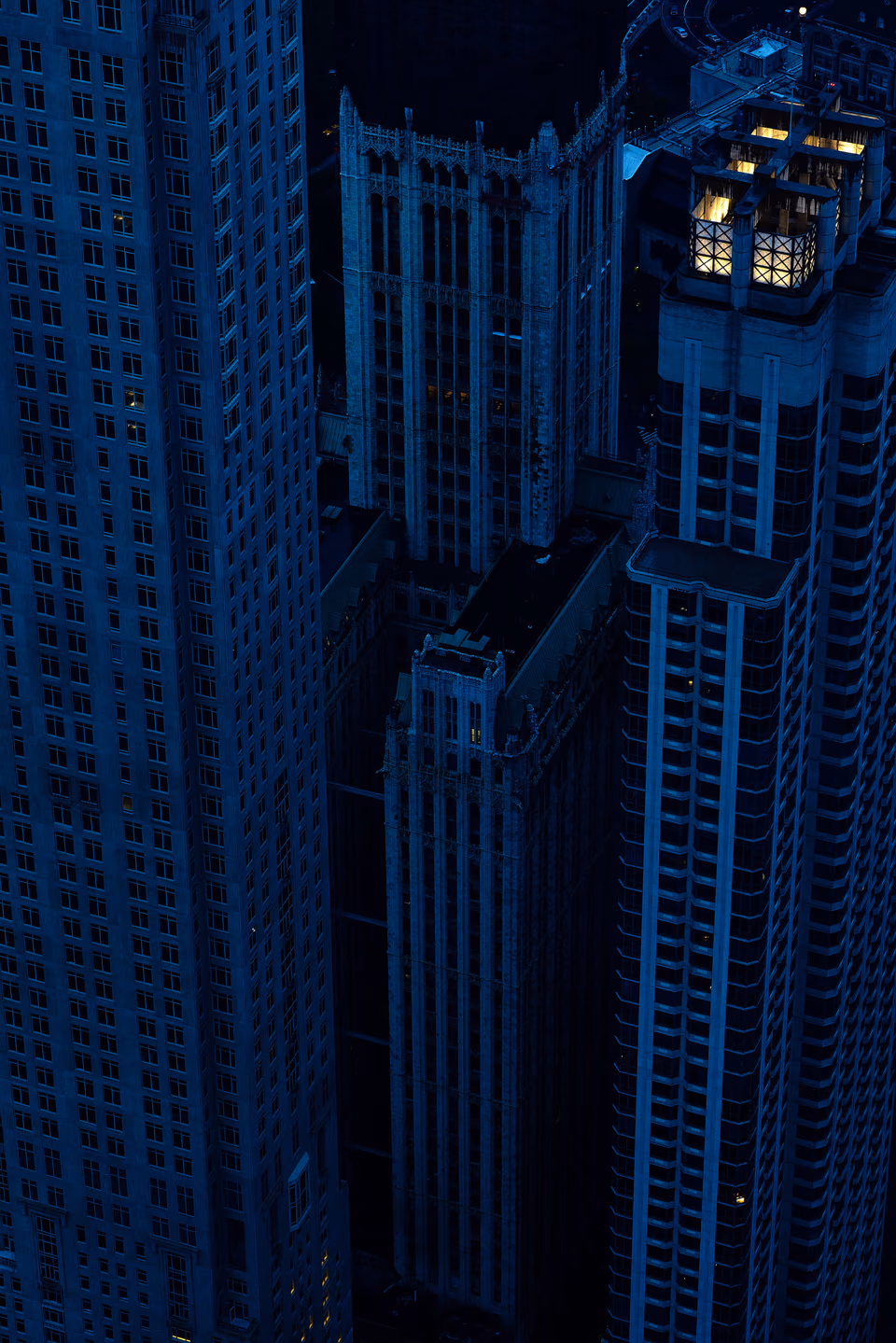 a view of a city at night with a skyscraper in the background
