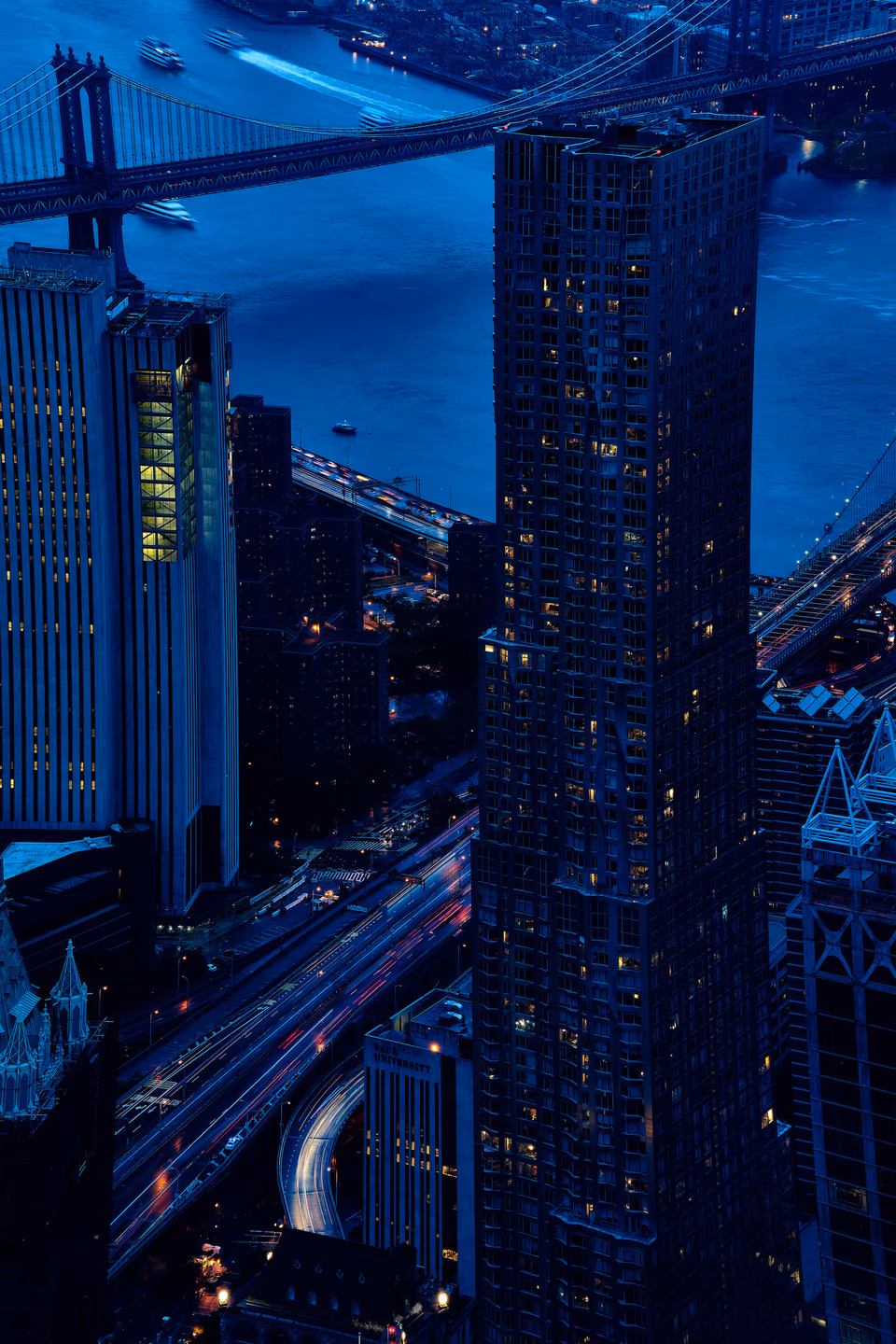 a city skyline with a bridge in the background
