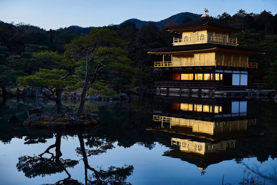 a building is reflected in a pond
