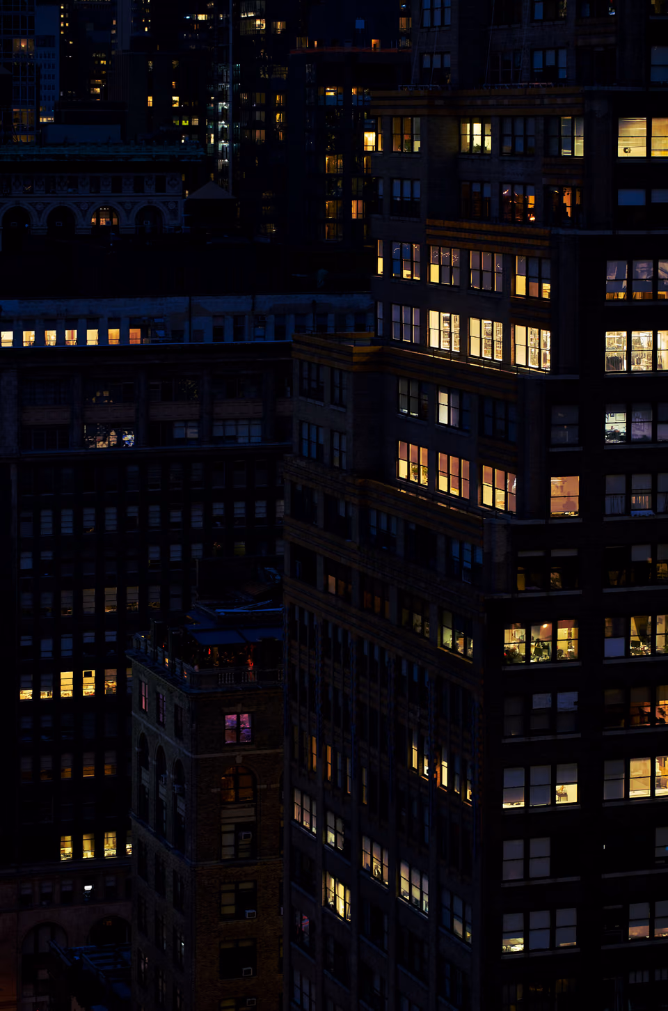 a city skyline with many buildings lit up at night
