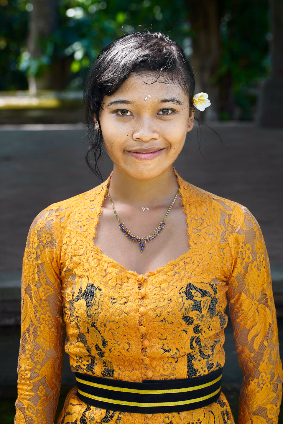 a woman in a yellow dress posing for a picture

