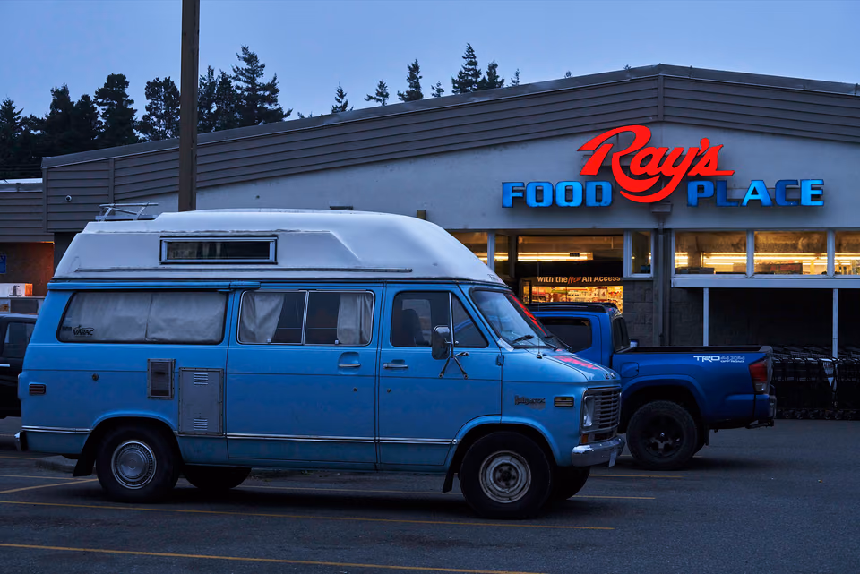 a van parked in front of a restaurant
