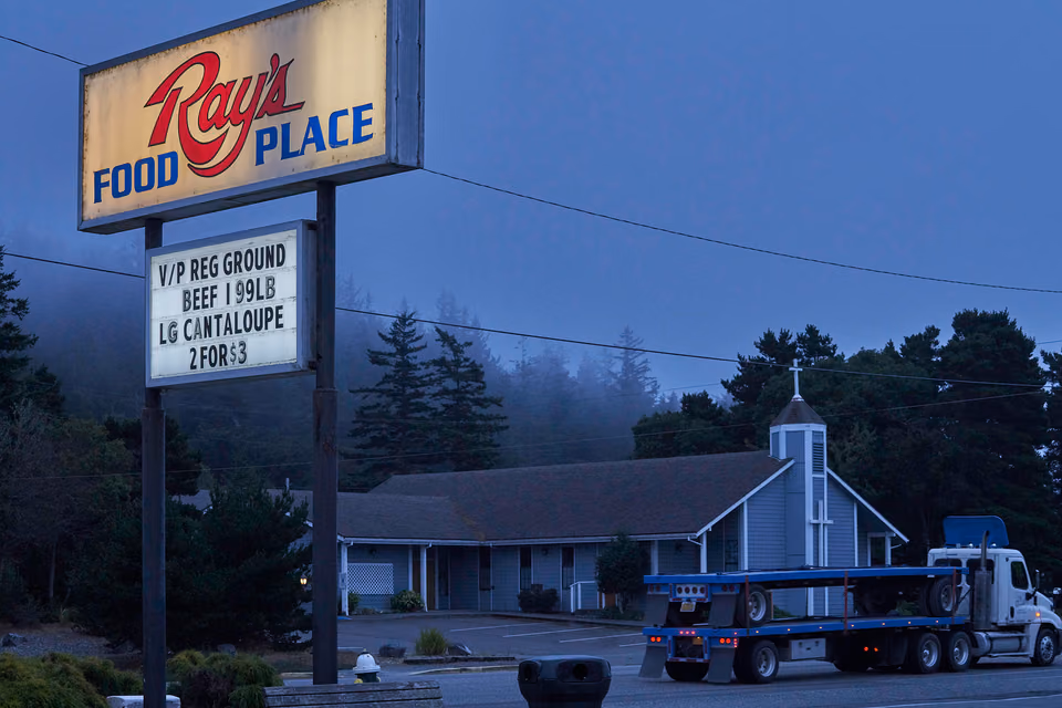 a truck is parked in front of a restaurant
