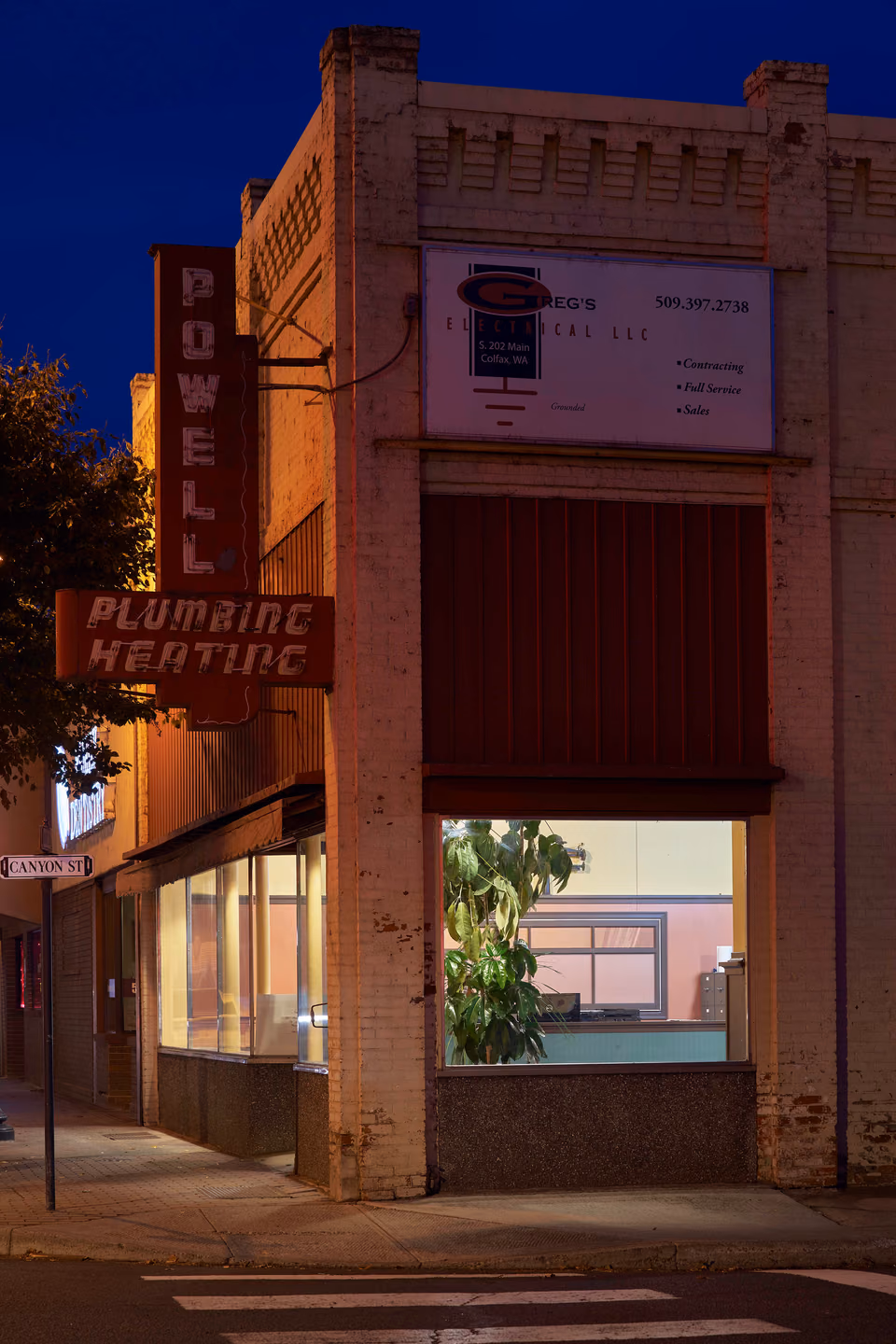 a building with a sign on it at night
