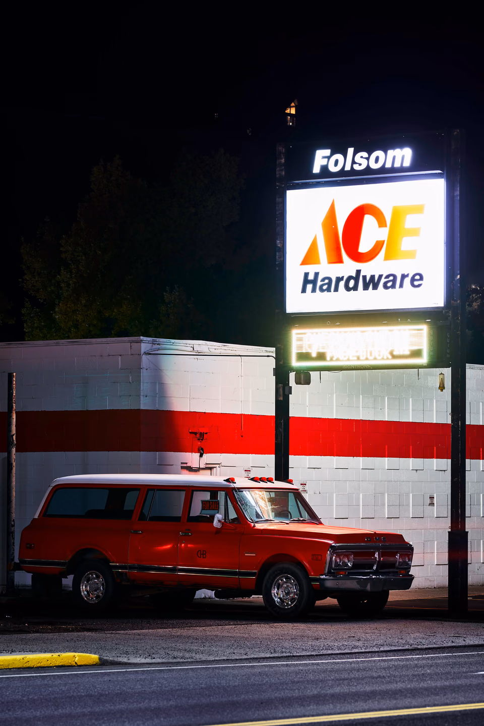 a red and white van parked in front of a hardware store
