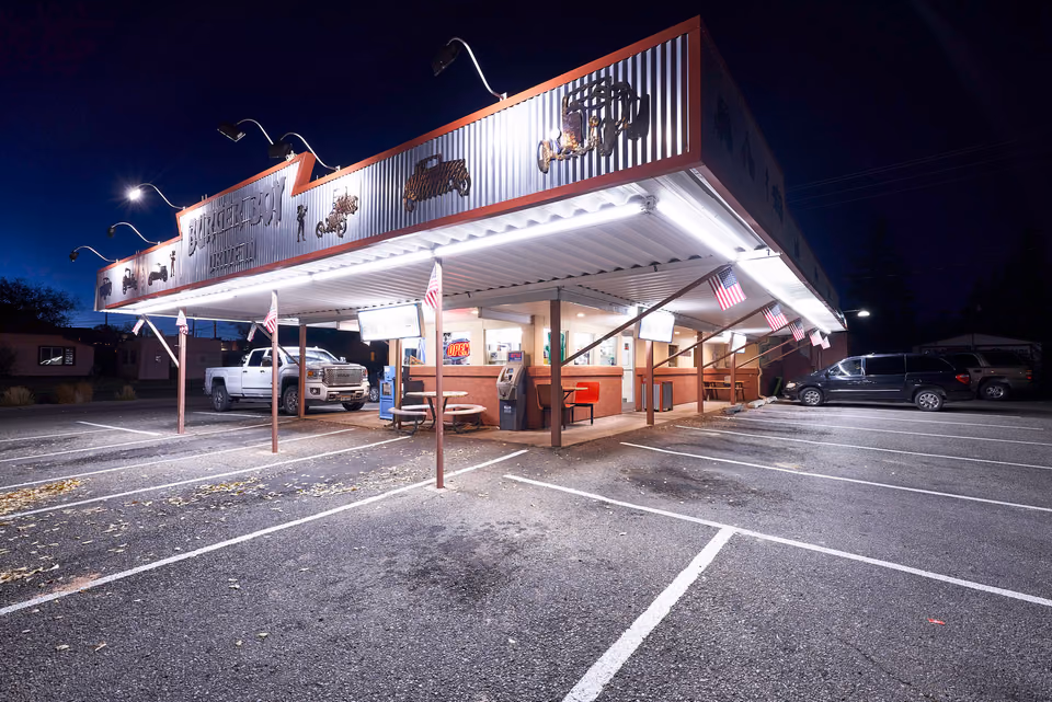 a restaurant with a car parked in front of it
