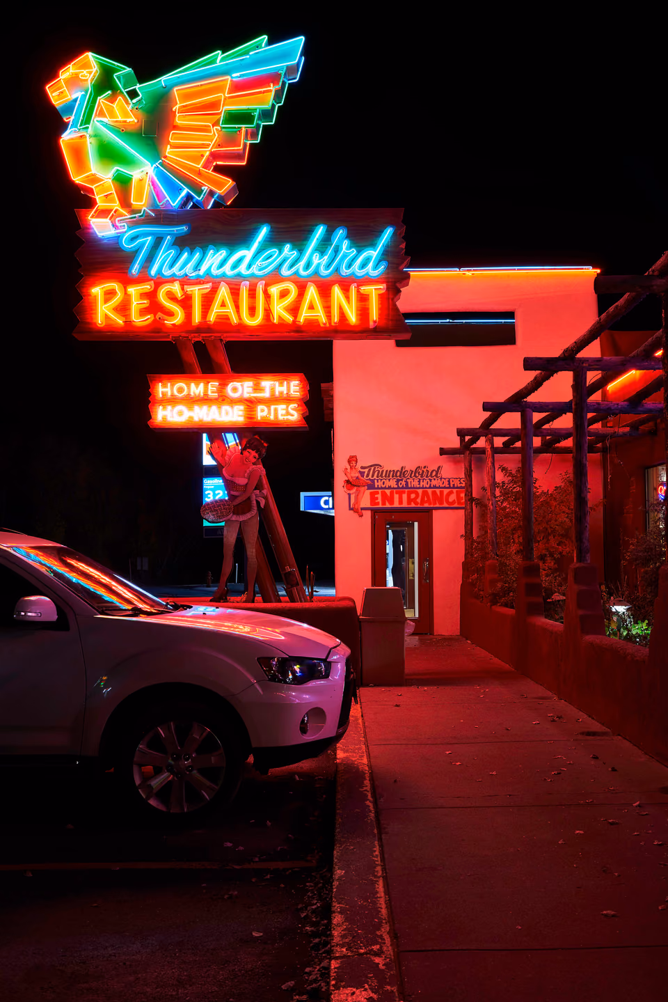 a car parked in front of a restaurant
