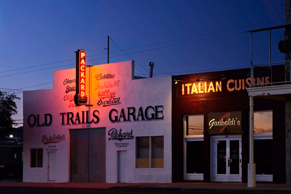 a building with a sign that says old trails garage
